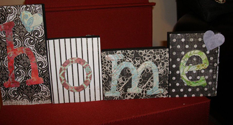 Wood blocks painted, then Mod Podged with scrapbook paper and letters